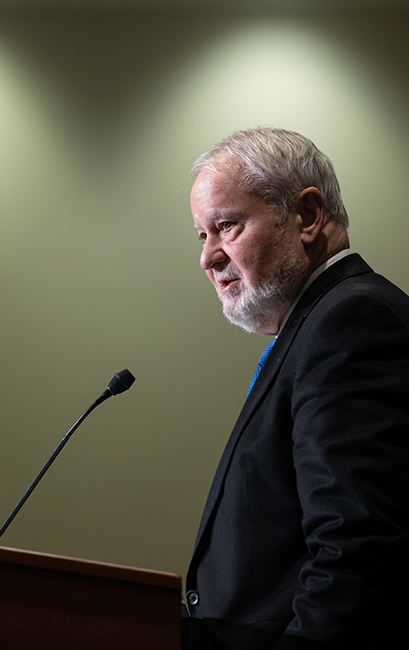 Dr. Larry Arnn speaking at a podium. 